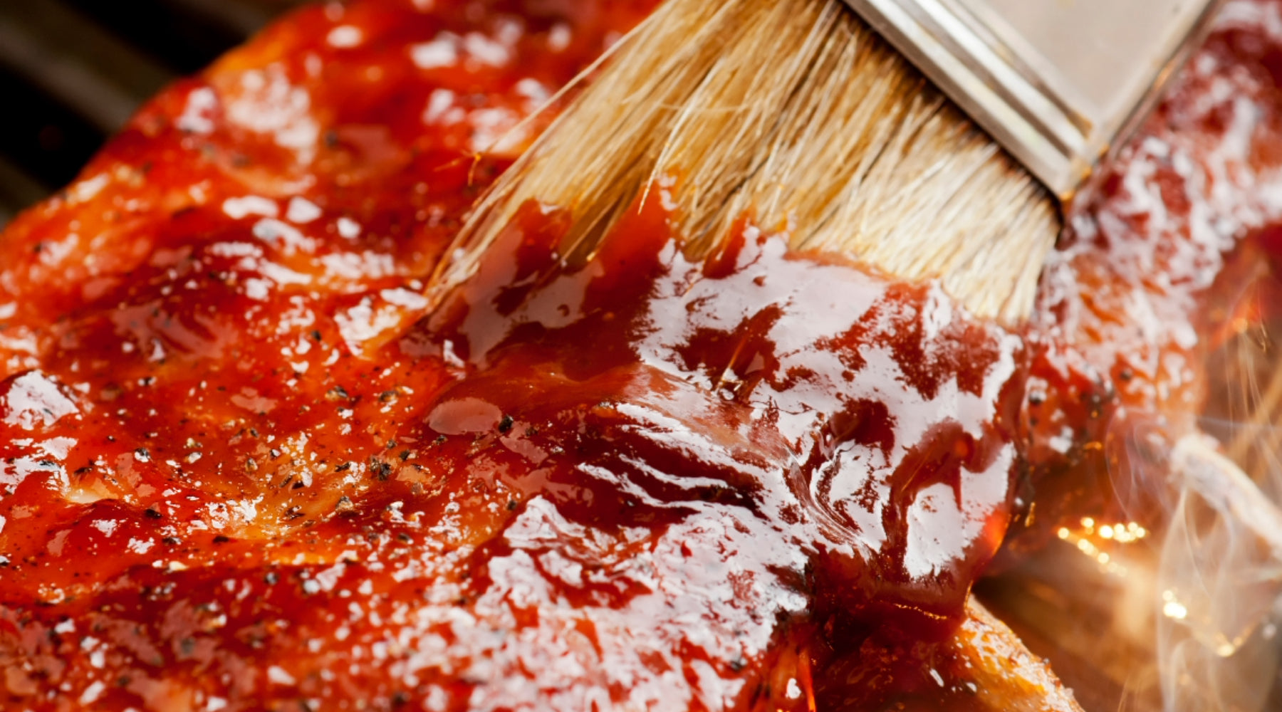 Brushing barbecue sauce on to ribs