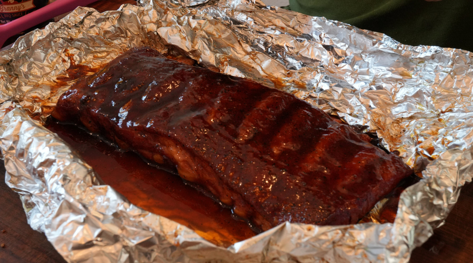A slab of ribs in it's foil that just came off the smoker