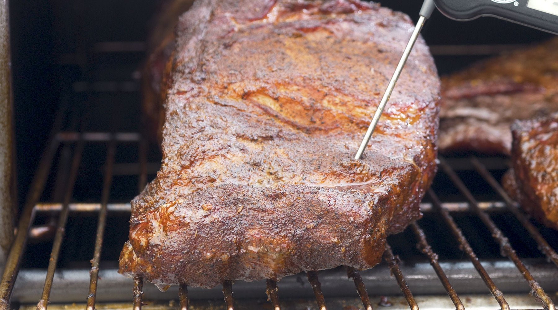 Using a ThermaPen to take the internal temp of the meat