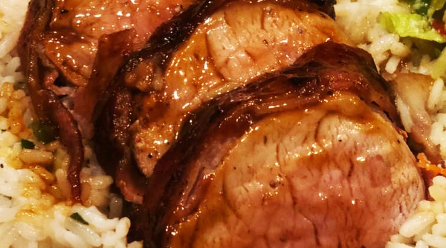 Pork tenderloin on a bed of rice