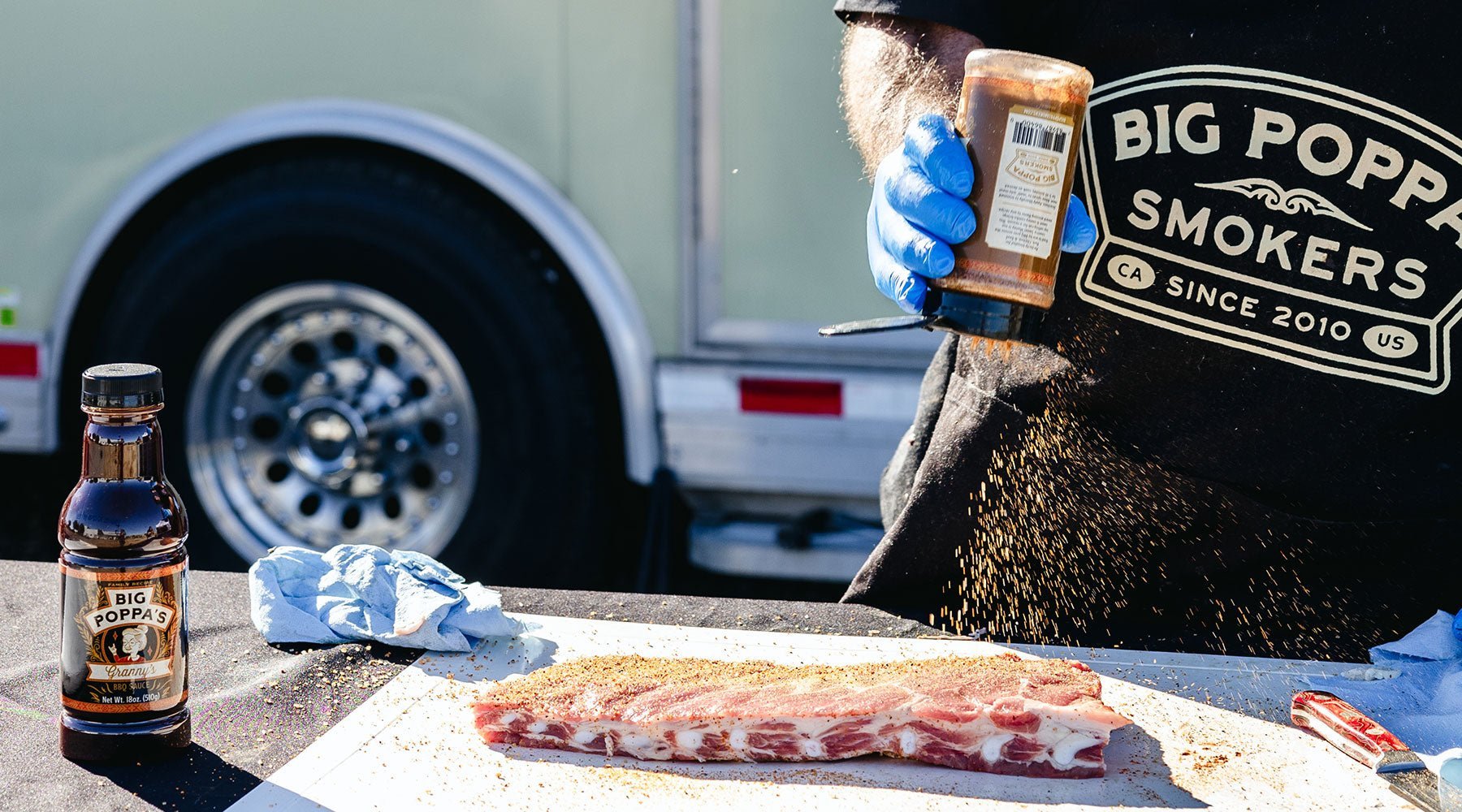 Big Poppa seasoning the ribs with Sweet Money a barbeque seasoning