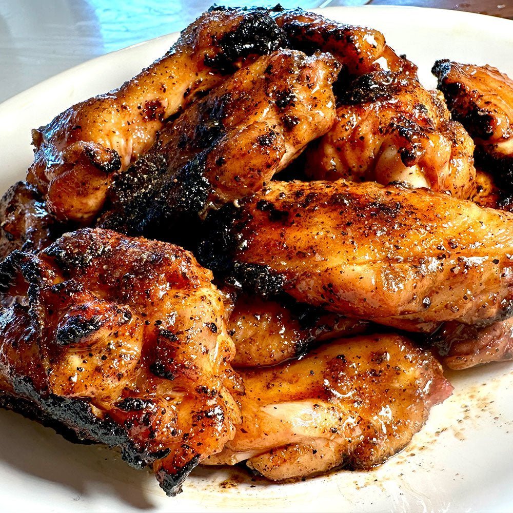 BBQ chicken wings with delicious bbq sauce on a white plate