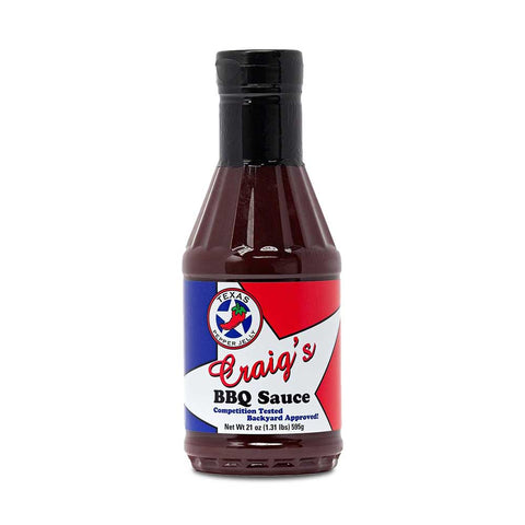 Bottle of Texas Pepper Jelly Craig’s BBQ Sauce, showcasing its vibrant label and promising a blend of sweet and spicy flavors ideal for enhancing meats and sides in both competitive and casual BBQ settings.