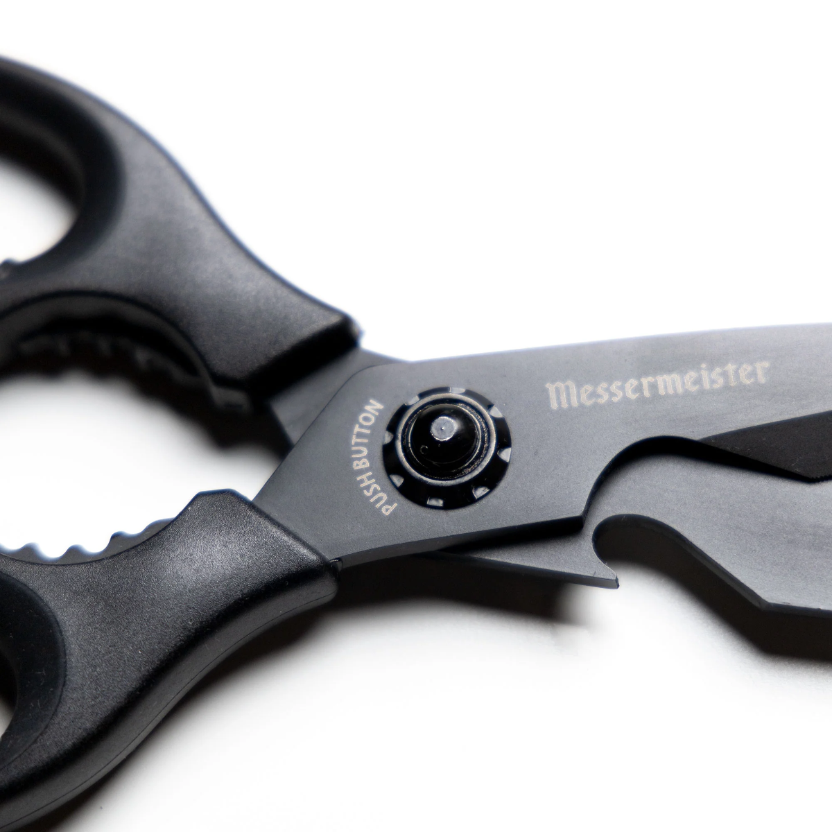Close-up image of the Messermeister 9" Push Button Take-Apart Shears. The shears feature a push-button mechanism for easy separation and cleaning. They have a sleek design with sharp blades and ergonomic handles, ideal for various cutting tasks in the kitchen. Displayed on a plain background, highlighting their functionality and design.