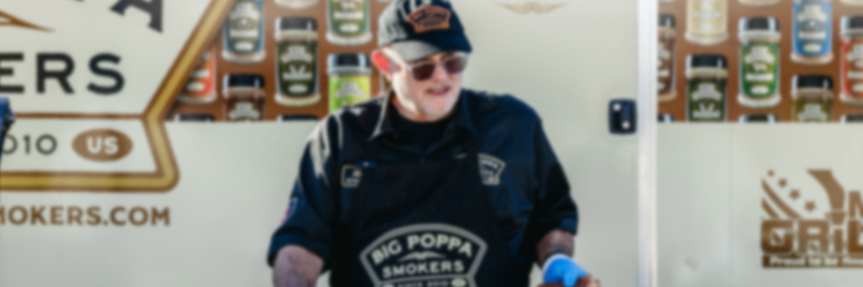 Big Poppa cooking wearing his Big Poppa shirts, branded apron and hat.