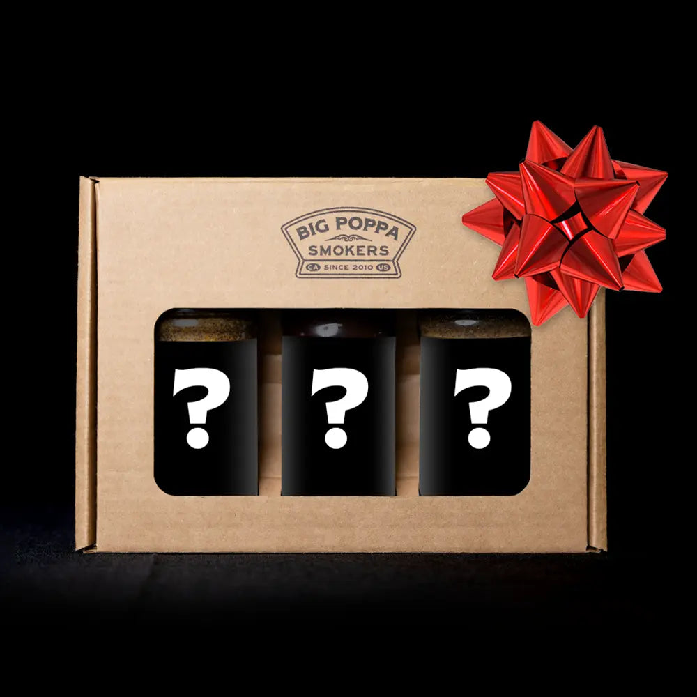 Box of Big Poppa Smokers with three black containers featuring question marks and a red bow on a black background.