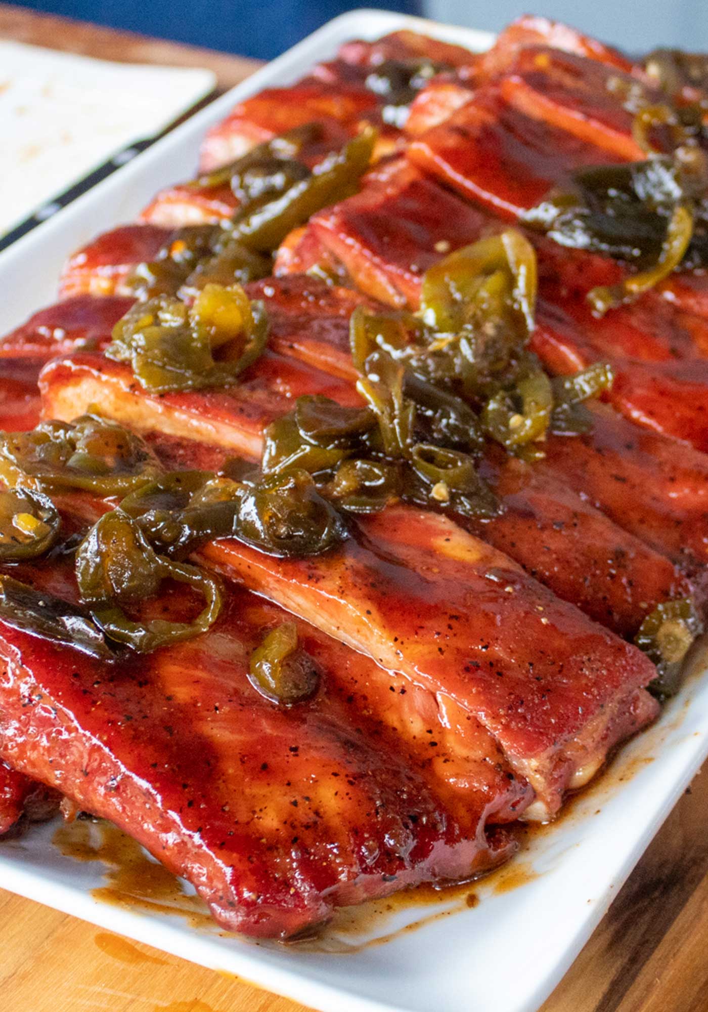 Slab of BBQ ribs sauced and topped with jalapenos