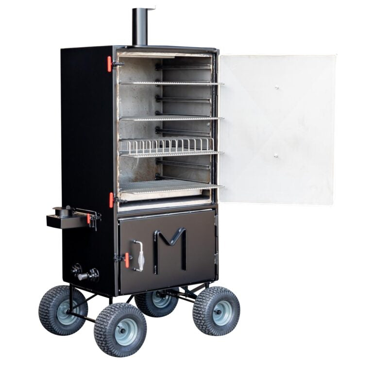 Front view of the Meadow Creek BX100 smoker with the upper door open, showing a rib rack and multiple stainless steel grates inside.