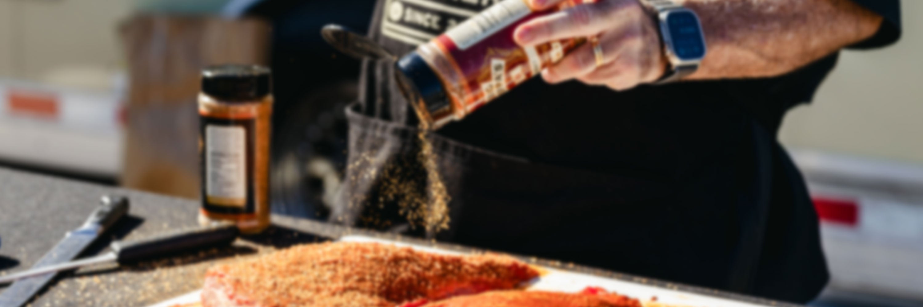 Big Poppa seasoning tri-tip with Sweet Money and Double Secret.