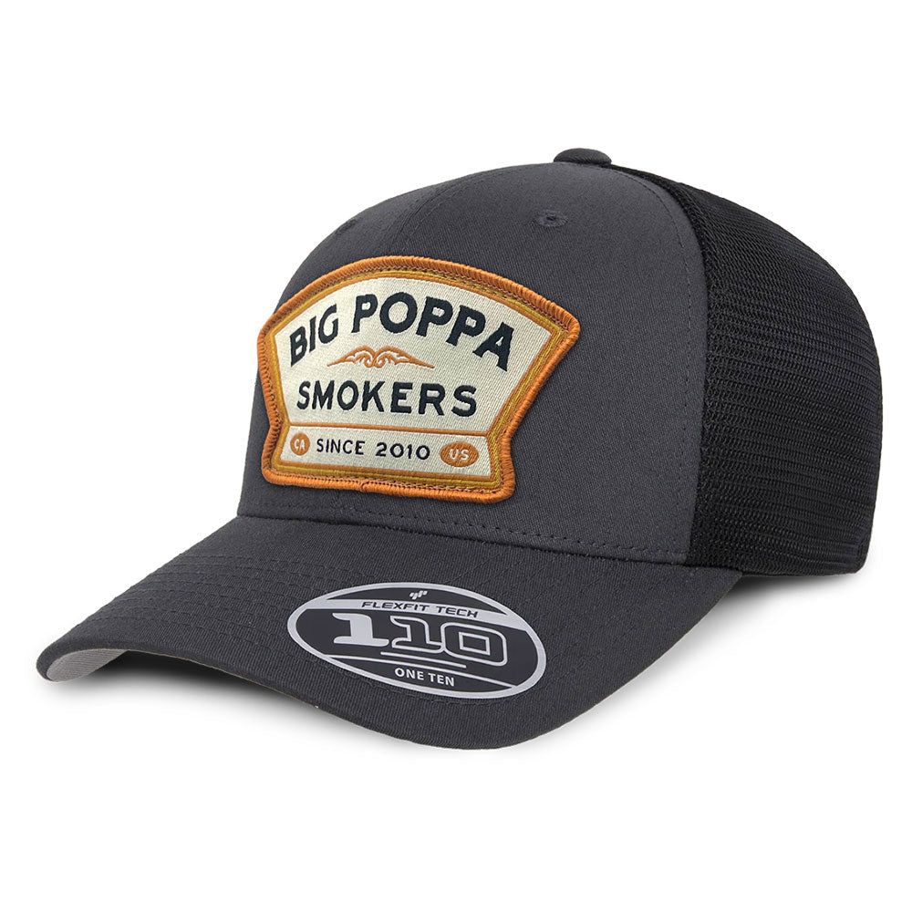 Charcoal gray and black trucker hat with beige-orange patch reading 'Big Poppa Smokers' and 'CA Since 2010' on the front.