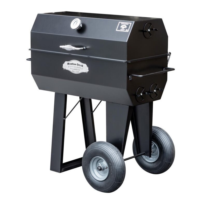 A side view of the Meadow Creek PR36 pig roaster with the lid closed, displaying the sleek black exterior and sturdy construction.