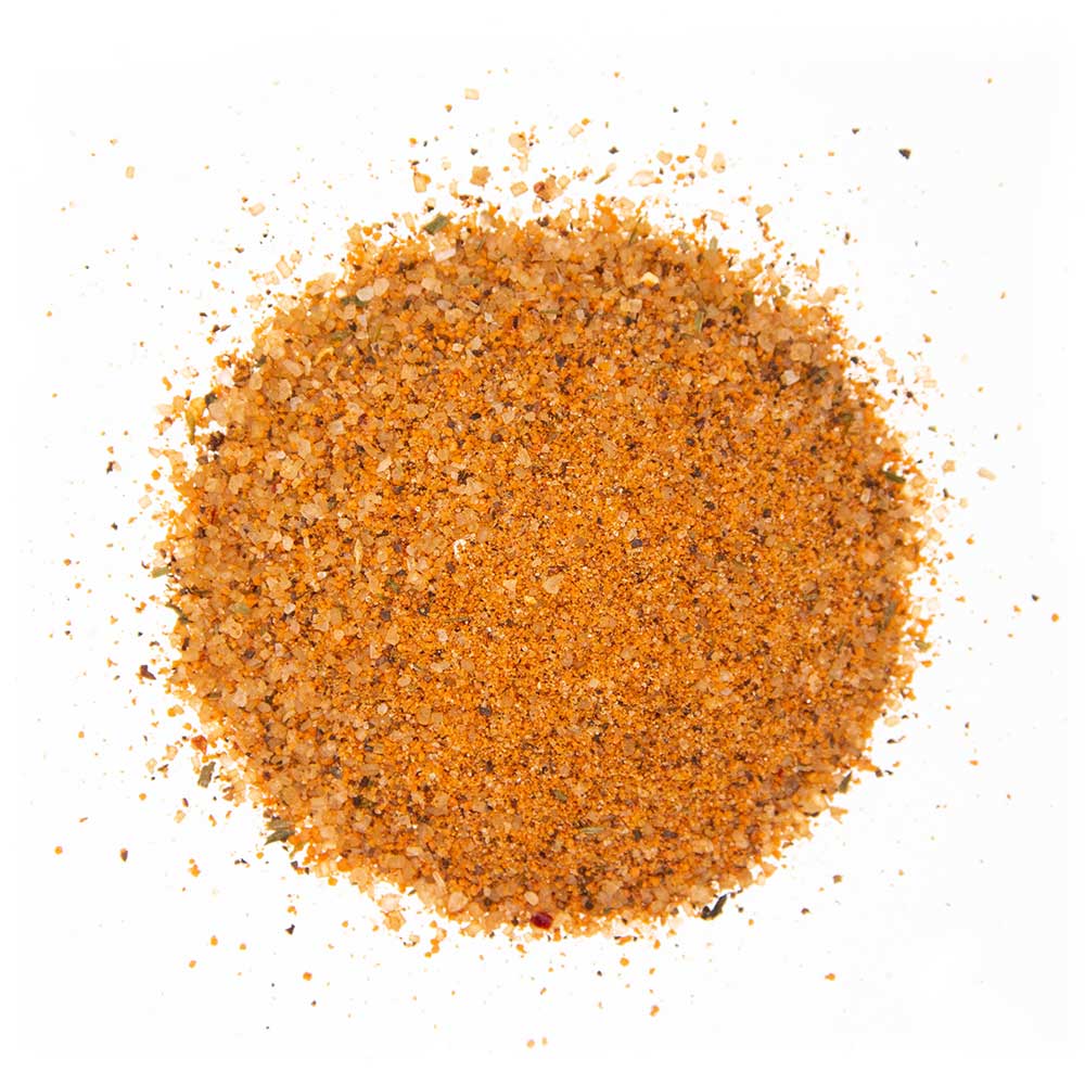 Close-up view of Big Poppa's Sweet Money Seasoning showing its textured granules consisting of various spices in shades of orange and brown.