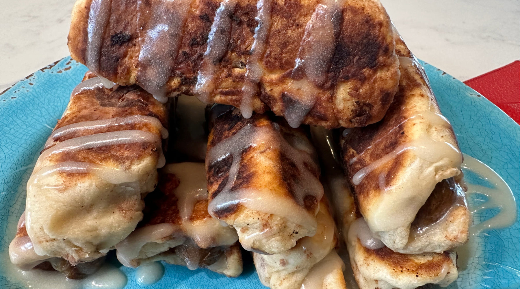 Plate full of pigs in a blanket that were made with cinnamon rolls