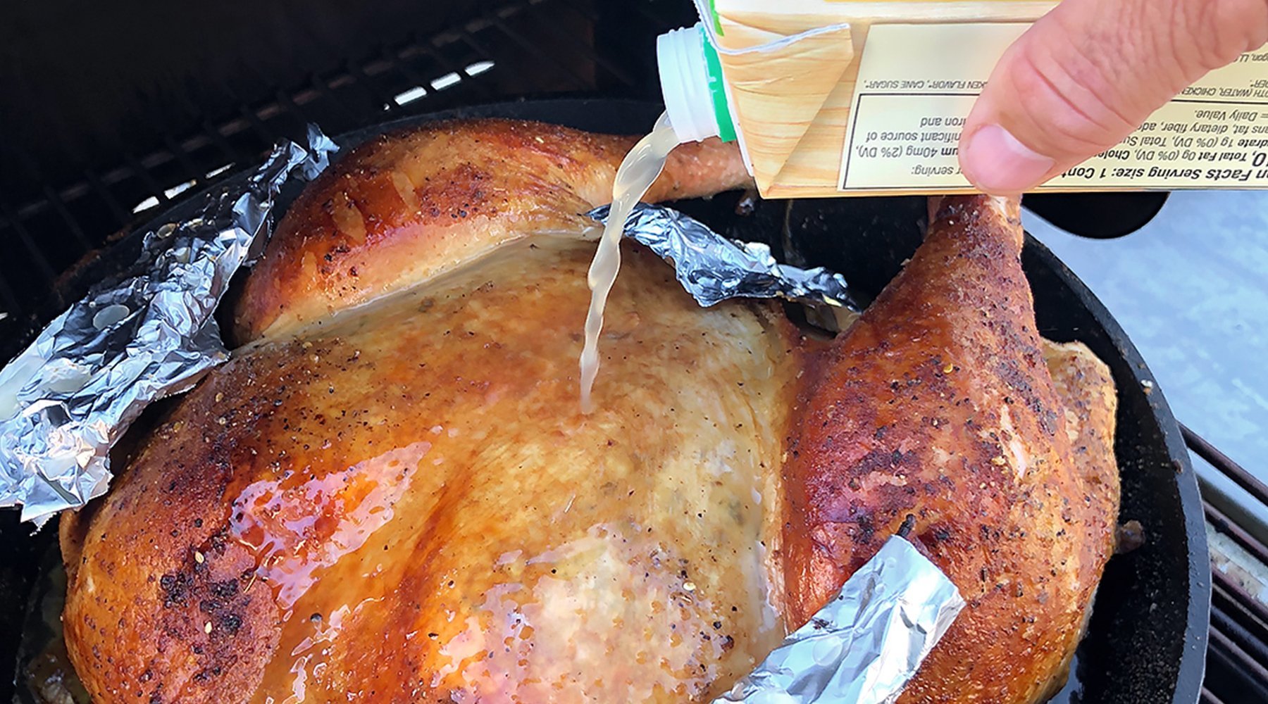 Adding broth to your turkey to keep moist