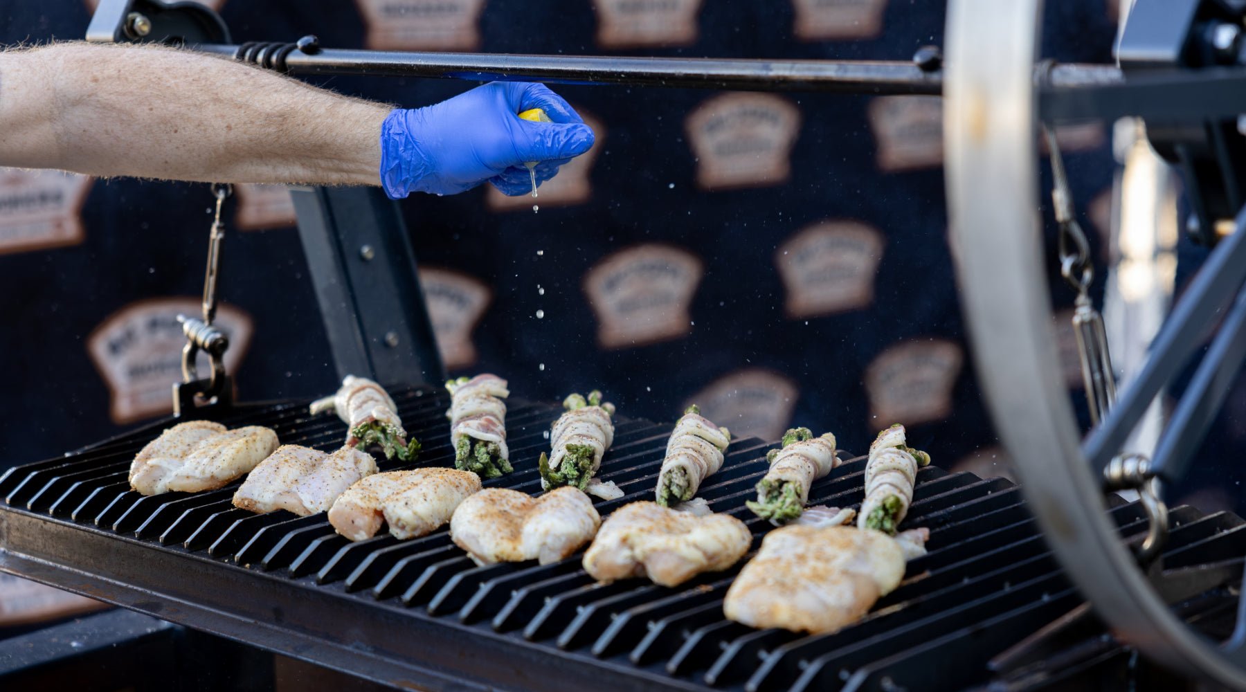 Squeezing a lemon over the chicken and vegetables on the grill