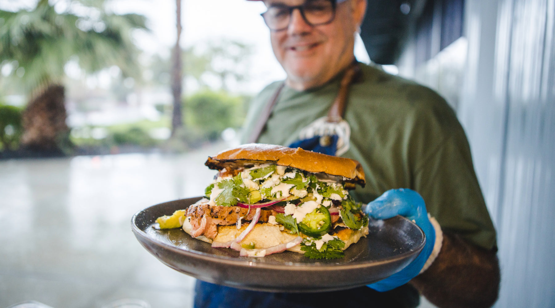 Sterling serving a pork tenderloin sandwich