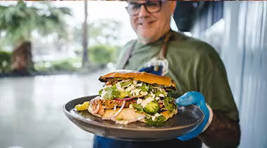 Sterling serving a pork tenderloin sandwich