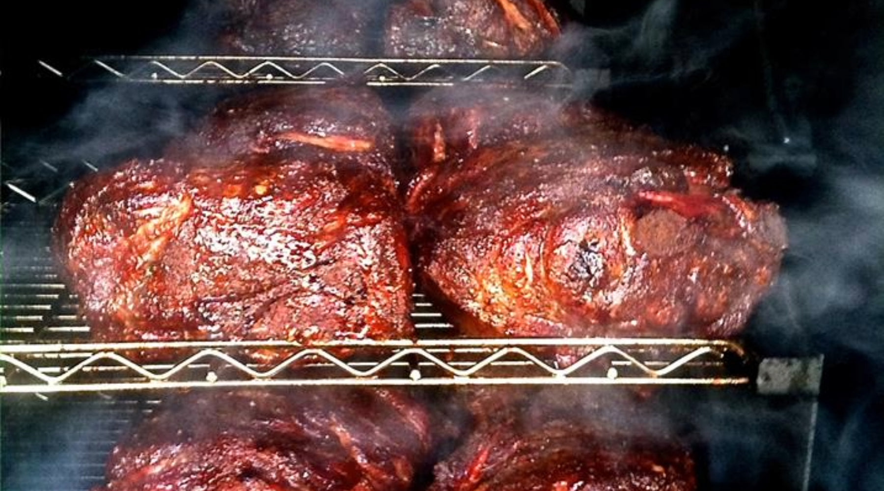 Pork shoulders smoking on the Ole Hickory and almost done.