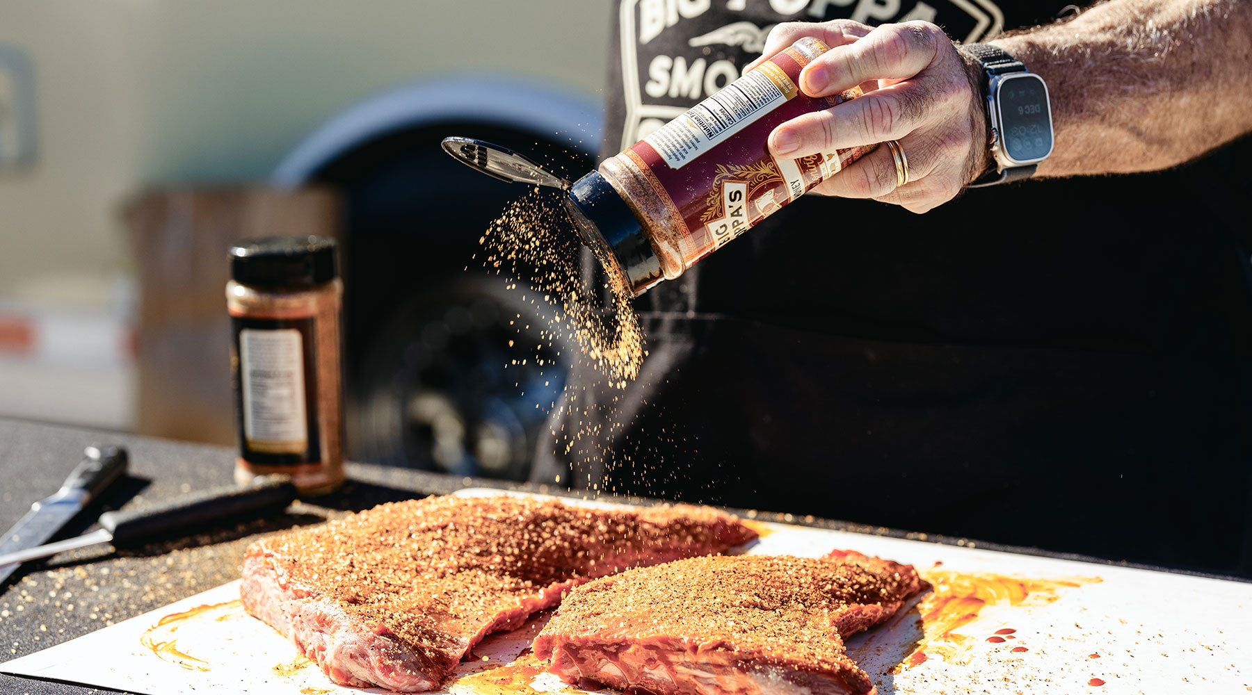 Big Poppa seasoning tri-tip before putting it on the Santa Maria.