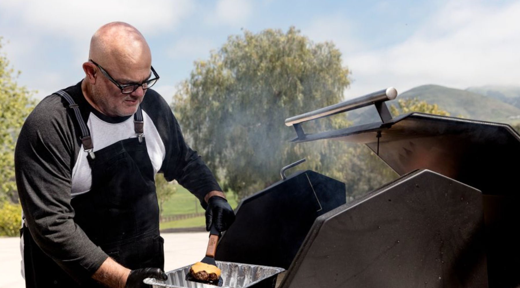 Sterling cooking burgers on the grill