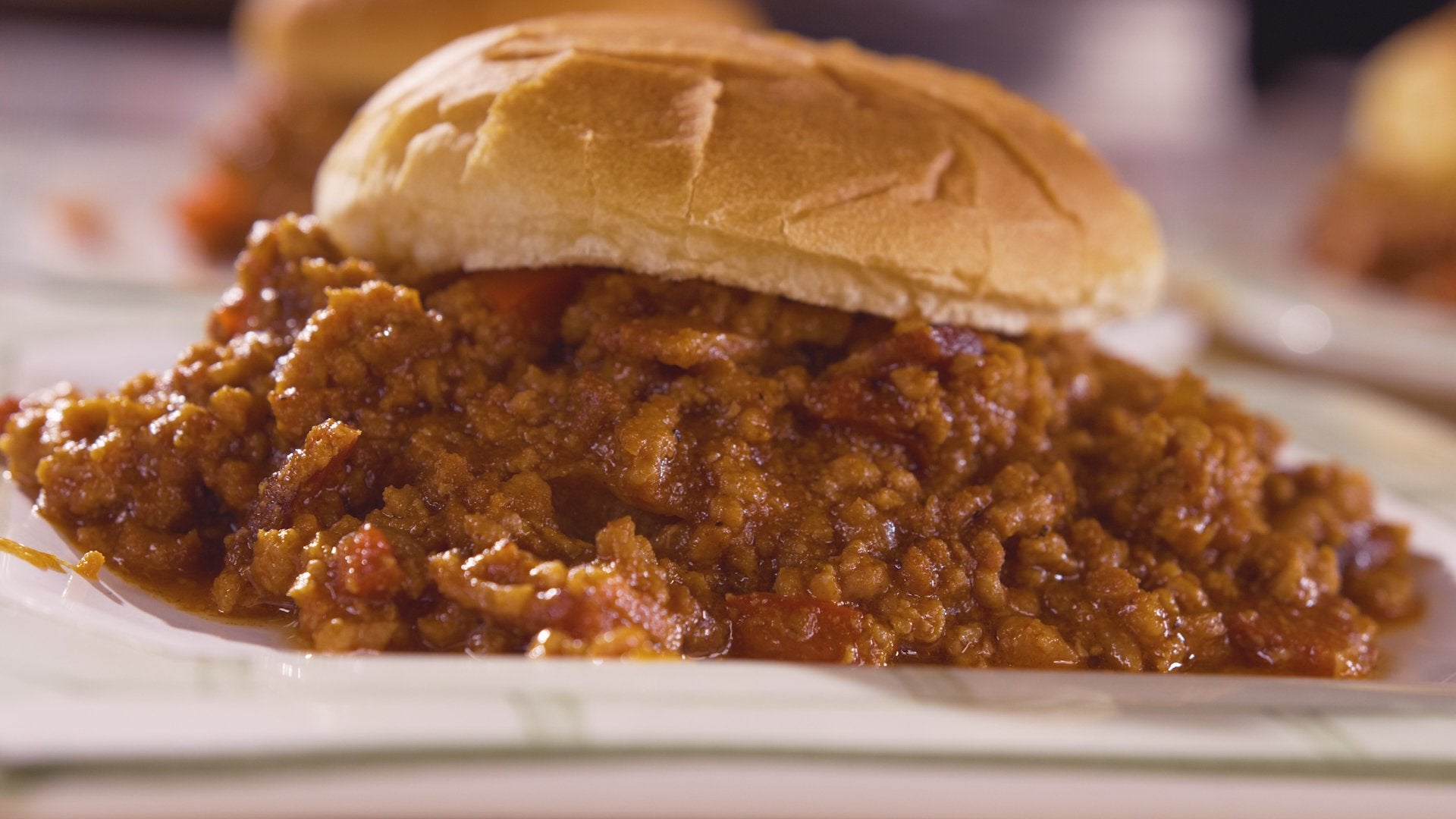 Overflowing Sloppy Joe on a bun.