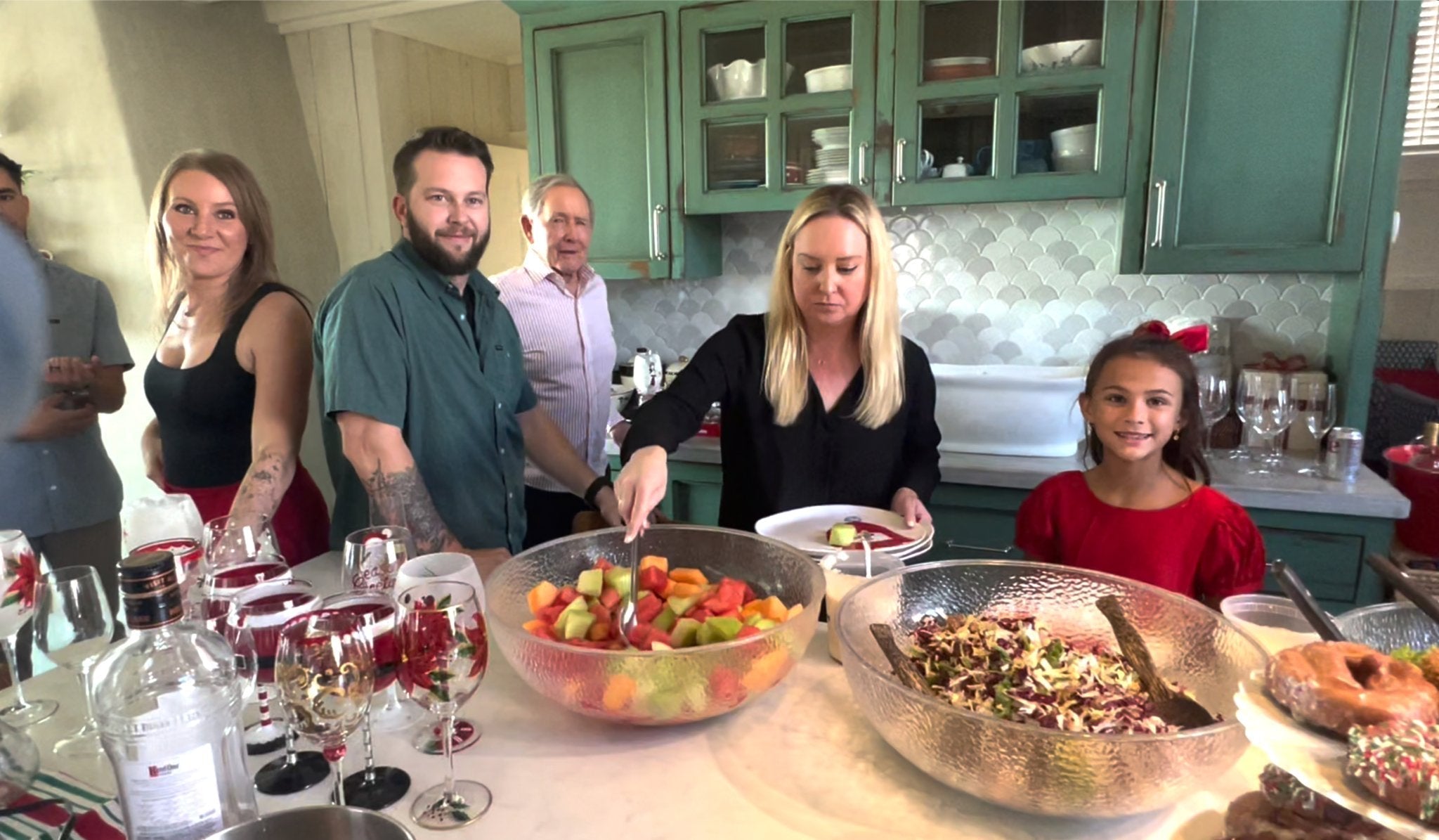 Family around the kitchen island preparing their holiday plate