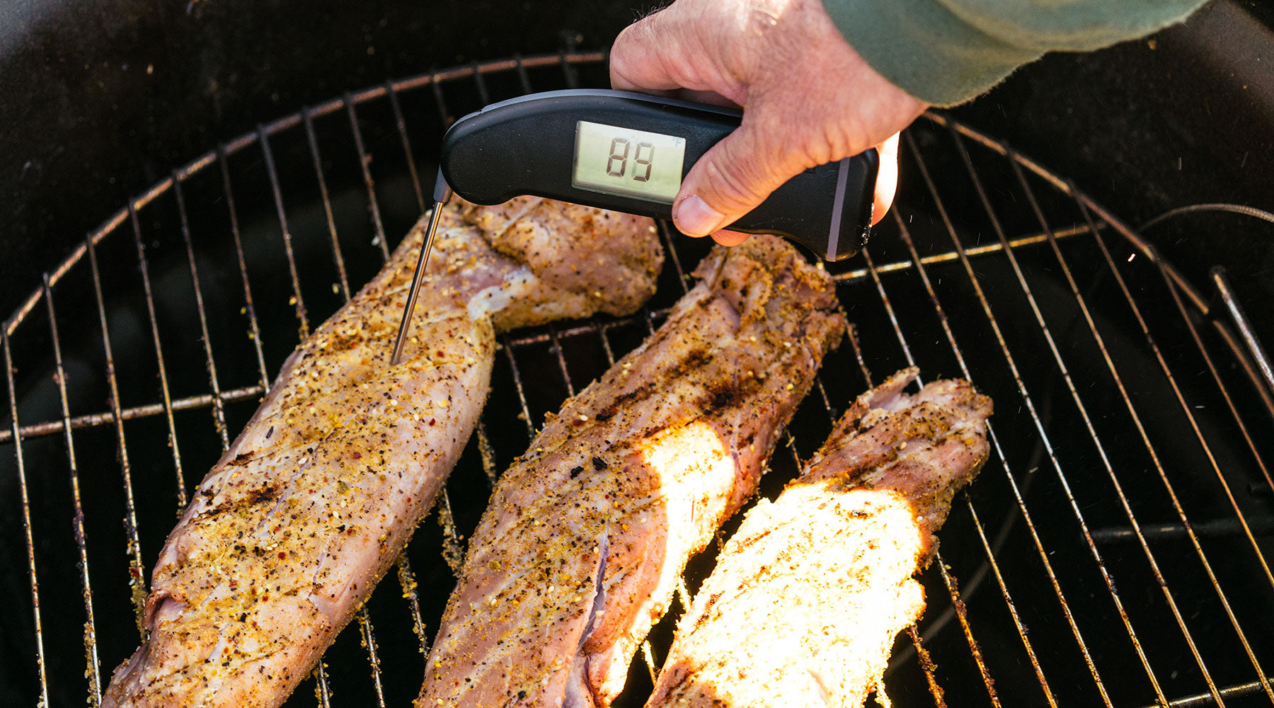 Using a temperature gauge to see if pork tenderloin is done.
