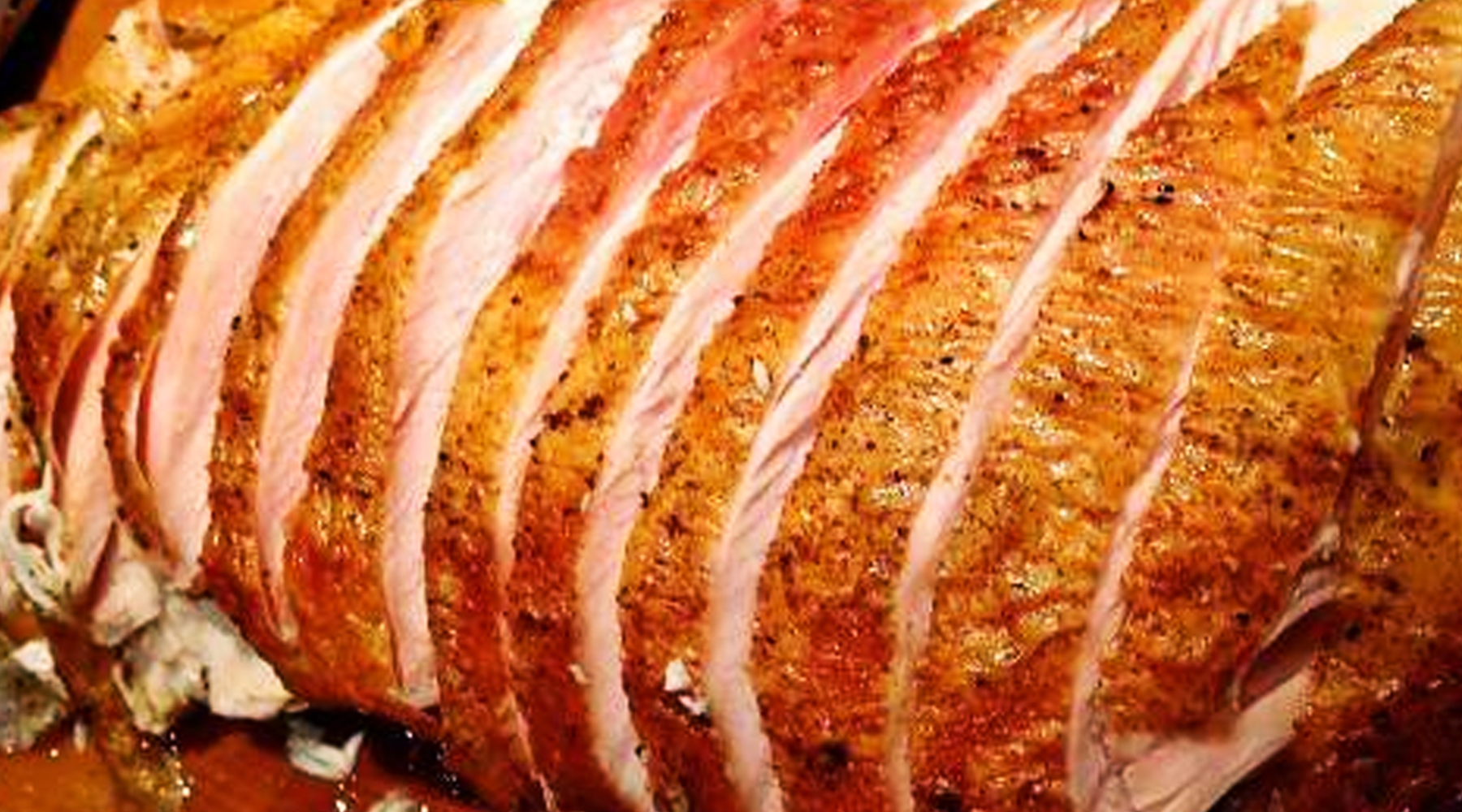 An up close image of a perfectly sliced turkey breast.