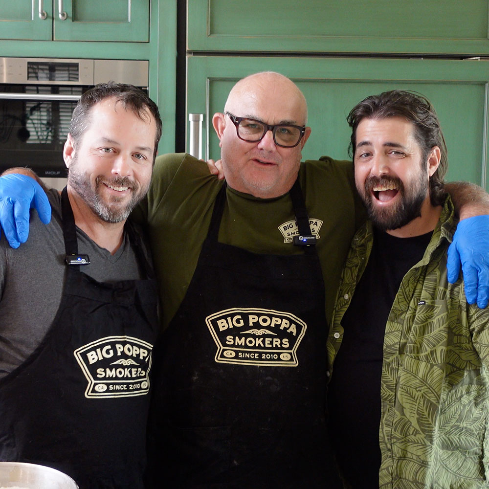 Photo of Sterling "Big Poppa Ball" with two of his sons cooking in the kitchen.