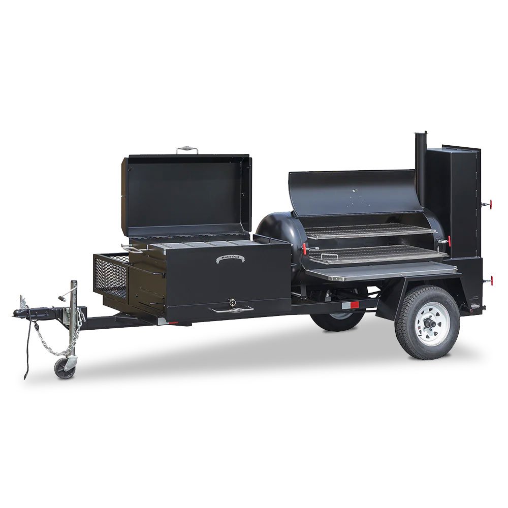 A large, black, trailer-mounted barbecue smoker with multiple grilling compartments. The smoker features a hitch for towing and is designed for outdoor cooking and catering events. The main grill lids are open, showing the cooking grates inside.