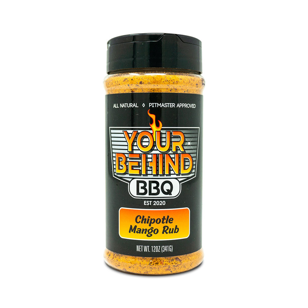 Jar of 'Your Behind BBQ Chipotle Mango Rub.' The black jar features a colorful label with 'Your Behind BBQ' in bold letters, indicating it is all-natural and pitmaster approved. The label also reads 'Chipotle Mango Rub' and 'Net Wt. 12oz (341g).'