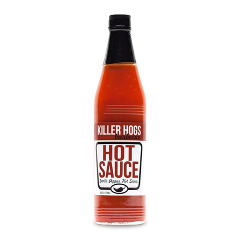 Bottle of Killer Hogs Garlic Pepper Hot Sauce, featuring a bold label with red and white accents, showcasing its ingredients like aged red peppers and garlic. Ideal for adding a moderate, flavorful heat to various dishes from BBQ to fast foods.