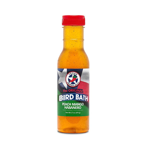 Bottle of Peach Mango Habanero Texas Bird Bath sauce, vibrant with colorful imagery of peaches, mangos, and peppers, indicating its use as a versatile marinade or glaze for enhancing various meats with a sweet and spicy flavor profile.
