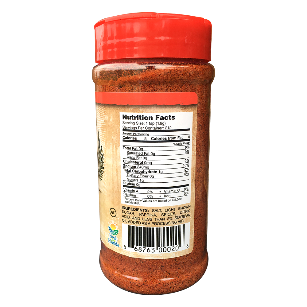 The side view of a container of Swamp Boys BBQ Rub with a red cap. The label shows the nutrition facts, including serving size (1 tsp), calories (5 per serving), and ingredients such as salt, light brown sugar, paprika, spices, and citric acid. The label also includes a "Certified Gluten-Free" logo and a "Fresh from Florida" logo.