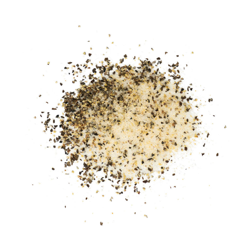 A close-up image of LC BBQ Rawhide All-Purpose seasoning scattered on a white surface. The seasoning consists of a mix of finely ground white and black granules.