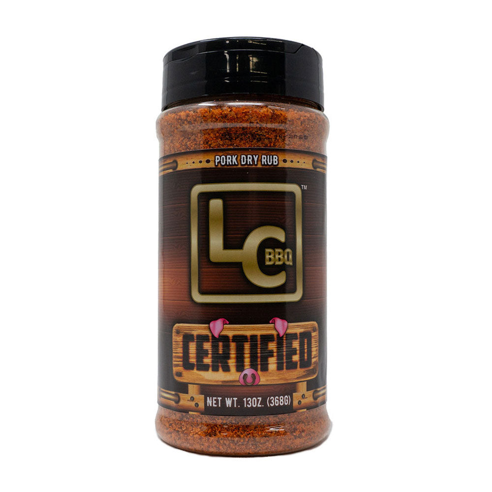A bottle of LC BBQ Pork Dry Rub. The bottle features a wooden-themed label with the LC BBQ logo and the word "Certified" in large letters. The label indicates that the bottle contains 13 ounces (368 grams) of pork dry rub seasoning.