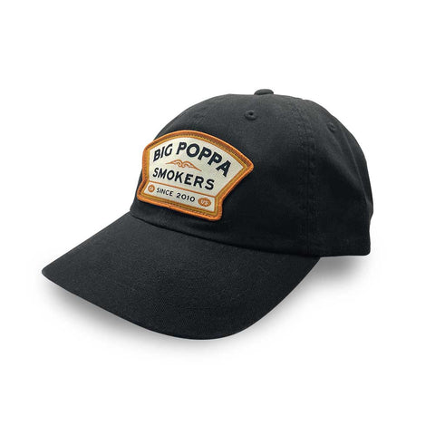 Black baseball cap featuring an embroidered patch with 'Big Poppa Smokers' and 'since 2010' in white and orange on a black background.