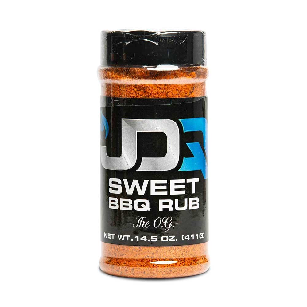 The front of a JDQ Sweet BBQ Rub container with a black label featuring bold white and blue text. The label reads "JDQ Sweet BBQ Rub The O.G." with a net weight of 14.5 oz (411g). The container is filled with a vibrant orange spice blend.