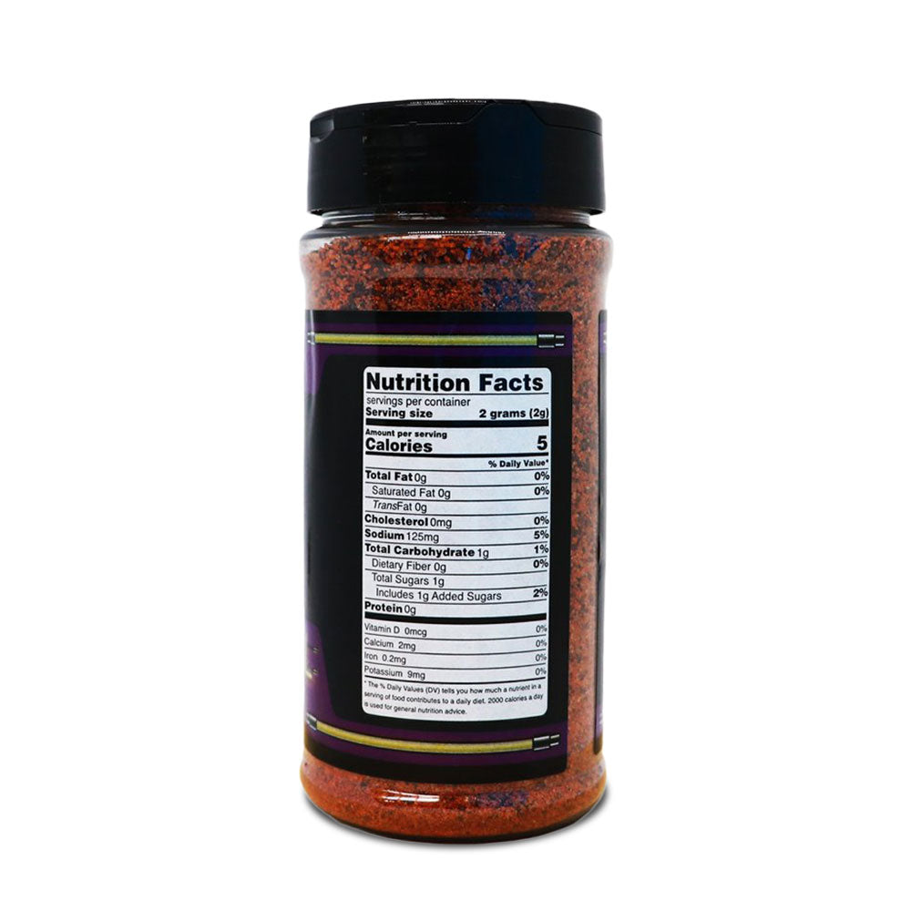 A bottle of LC BBQ Last Call Dry Rub viewed from the back, showing the nutrition facts label. The label details serving size, calories, and other nutritional information, such as sodium and carbohydrate content. The bottle is filled with a reddish-brown spice mixture.
