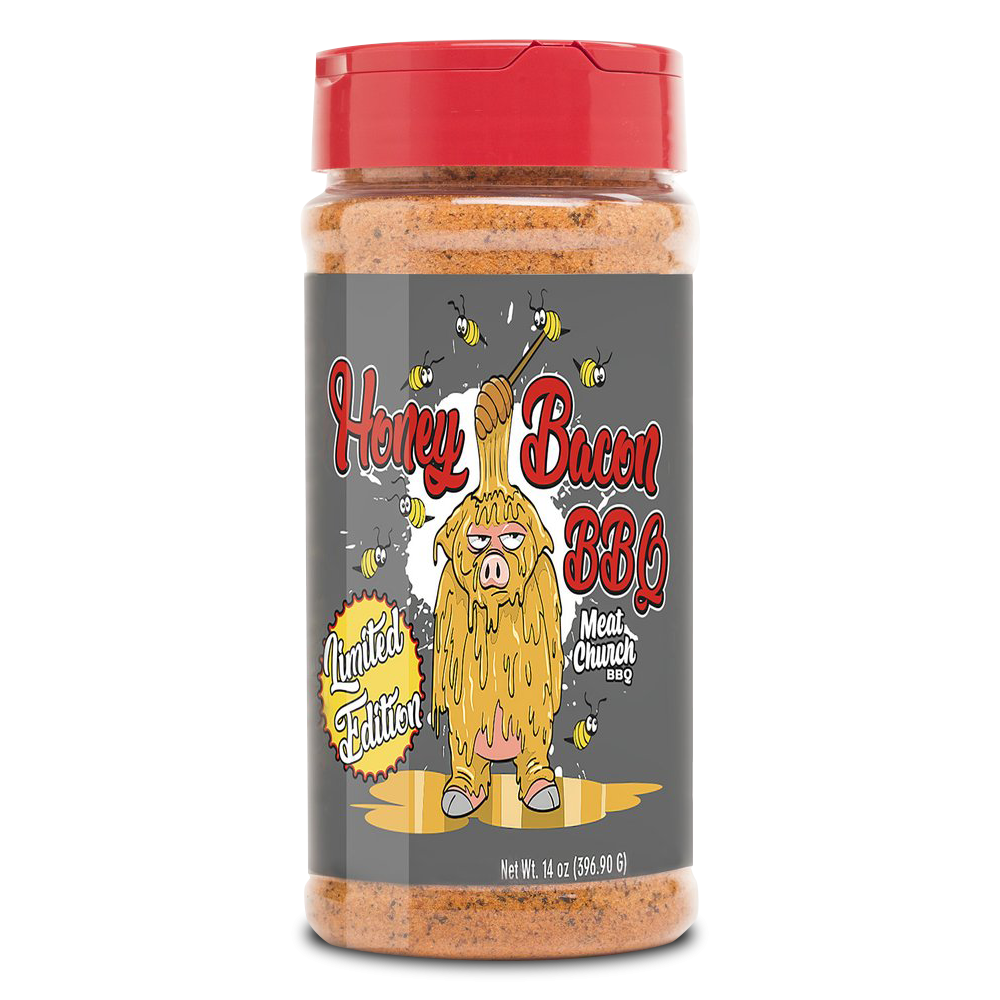 A 14-ounce jar of Meat Church Honey Bacon BBQ Rub. The label is gray with red text and features a cartoon pig covered in honey, holding a honey dipper, with bees flying around. The jar has a red lid and contains a coarse, reddish-brown spice mix. The label also indicates it is a limited edition.