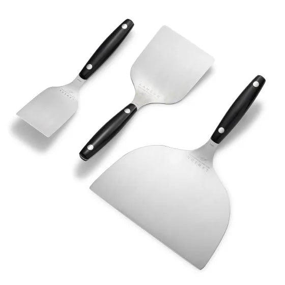 Three stainless steel spatulas with black handles, arranged diagonally from smallest to largest on a white background.