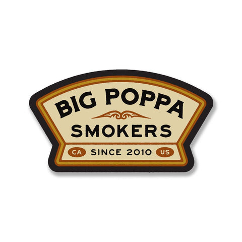 Decorative cream-colored arched sticker with the logo of 'Big Poppa Smokers' in bold black letters, accented with a golden trim and a stylized smoke motif, marked 'CA Since 2010 US' at the bottom.