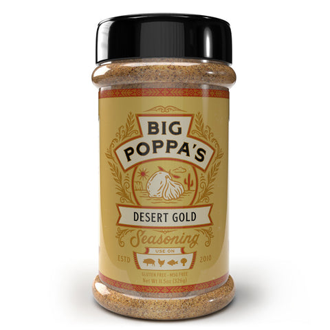 A spice bottle labeled 'Big Poppa's Desert Gold Seasoning', displaying a golden label with ornate tribal patterns and an illustration of garlic cloves. The label mentions it's gluten-free and MSG-free, established in 2010.