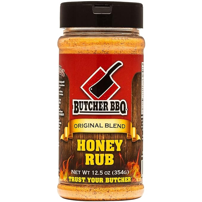 The front of a jar of Butcher BBQ Original Blend Honey Rub with a black lid. The label features a red background with the Butcher BBQ logo and a black meat cleaver icon. The label reads 'Original Blend Honey Rub' and specifies the net weight as 12.5 ounces (354 grams). The bottom of the label includes the tagline 'Trust Your Butcher.'