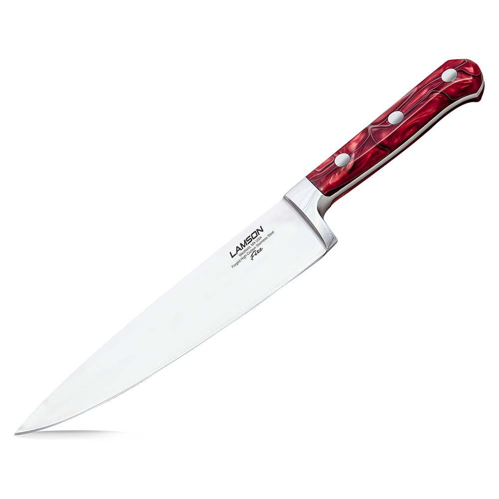 Close-up of the Lamson 8" Chef's Knife - Fire Series, showcasing its sharp, precision blade and striking red and black handle. The knife is displayed on a cutting board with fresh vegetables, emphasizing its professional quality and vibrant design perfect for any kitchen.