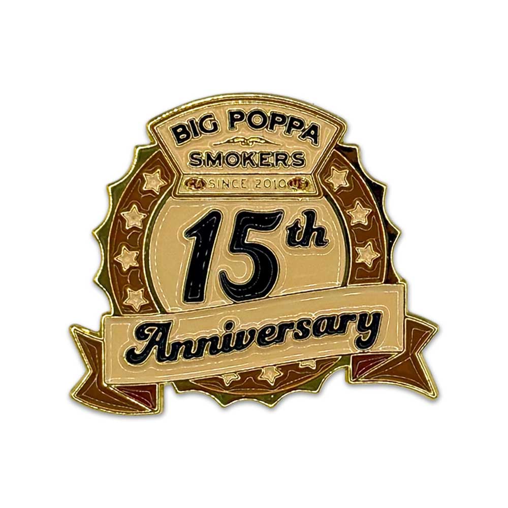 close up of shiny gold commemorative pin for the Big Poppa Smokers 15th Anniversary celebration