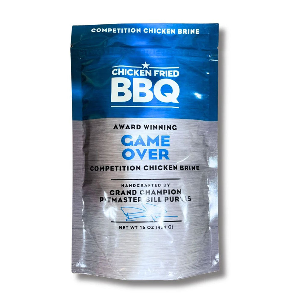 The front of a package of Chicken Fried BBQ Competition Chicken Brine. The package has a blue and silver design and reads 'Award Winning Game Over Competition Chicken Brine.' It is handcrafted by Grand Champion Pitmaster Bill Purvis and has a net weight of 16 ounces (454 grams).