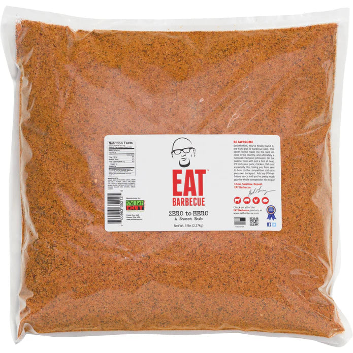 A 5-pound bag of EAT Barbecue Zero to Hero sweet rub. The bag is clear, showing the orange-colored seasoning inside. The label features a stylized image of a man's face wearing glasses above the brand name "EAT Barbecue" in red text. It is labeled as "Zero to Hero A Sweet Rub." The label also includes nutritional facts, barcode, and a brief description about the rub.