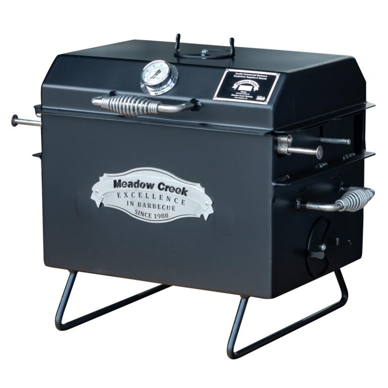 The Meadow Creek BBQ18 Chicken Cooker with the lid open and the grate lifted. The image highlights the spacious cooking area and the Meadow Creek branding.
