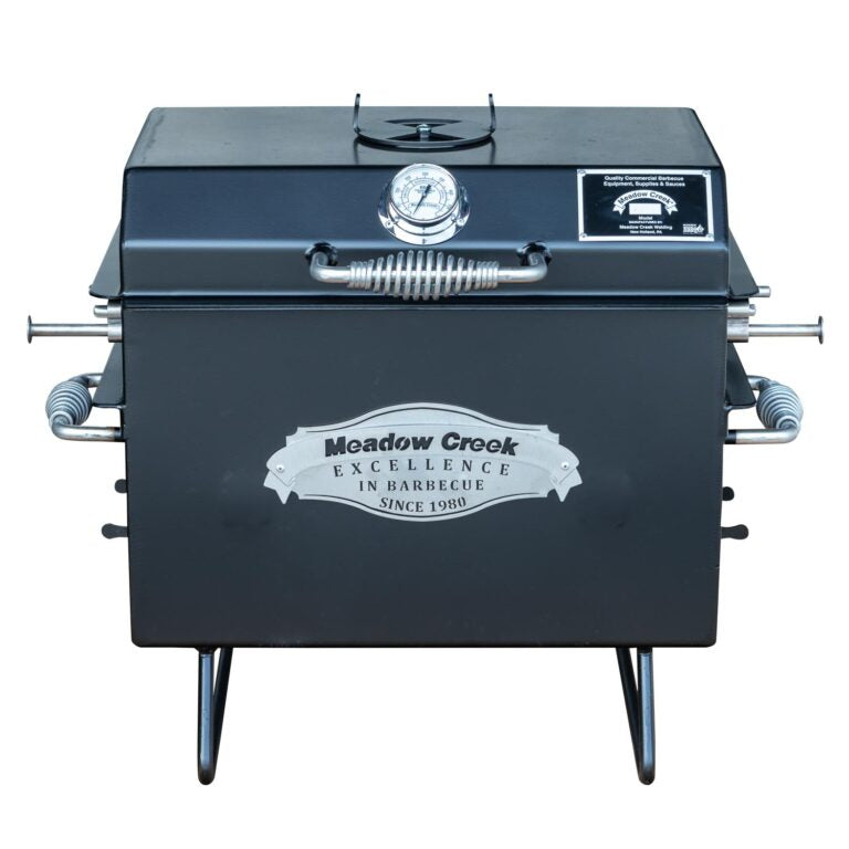 Front view of the Meadow Creek BBQ18 Chicken Cooker with the lid closed. The cooker features a temperature gauge on the lid and the Meadow Creek logo prominently displayed on the front.